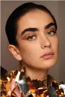  ?? ?? Gold standard: add some sparkle with a new metallic eye shadow. Photograph: Filippo Fortis/Imaxtree.com