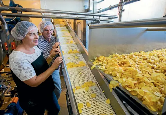  ?? PHOTO: MYTCHALL BRANSGROVE/FAIRFAX NZ ?? Heartland Potato Chips owner Raymond Bowan and his daughter, general manager Charlotte Bowan, keep an eye on their new range of premium crafted kettle chips as they rise in the fryer.