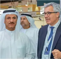  ??  ?? Sultan bin Saeed Al Mansouri, UAE Minister of Economy, with an Italian trade executive at the Annual Investment Meeting in Dubai on Wednesday. — Supplied photo