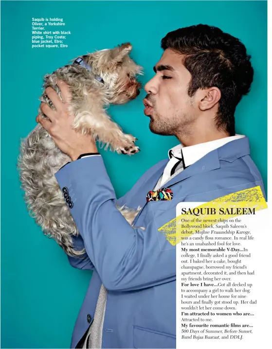  ??  ?? Saquib is holding Oliver, a Yorkshire Terrier. White shirt with black piping, Troy Costa; blue jacket, Etro; pocket square, Etro