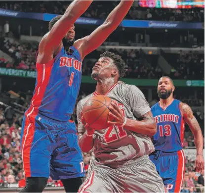  ?? | GETTY IMAGES ?? Jimmy Butler goes to the basket against Andre Drummond of the Detroit Pistons on Saturday at the United Center.