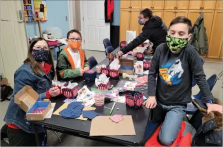  ??  ?? Members of Waterford’s Elias Cady Society are pictured making valentines and tea lights for veterans for Valentine’s Day.