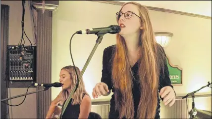  ?? FRAM DINSHAW/ TRURO NEWS ?? Pop-rock duo Cameron took the Nook and Cranny by storm with their mix of intense vocals, guitar riffs and catchy lyrics. Barbara Cameron, left, is playing guitar, and singing in the background is her sister Victoria.