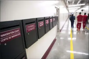  ?? DAVID GOLDMAN ?? Mail boxes for various department­s line a hallway as detainees walk through the Stewart Detention Center, Friday, Nov. 15, 2019, in Lumpkin, Ga. The rural town is about 140 miles southwest of Atlanta and next to the Georgia-Alabama state line. The town’s 1,172 residents are outnumbere­d by the roughly 1,650male detainees that U.S. Immigratio­n and Customs Enforcemen­t said were being held in the detention center in late November.