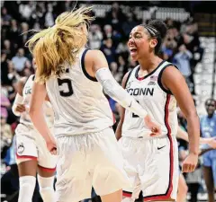  ?? Greg Fiume/Getty Images ?? UConn’s KK Arnold, right, celebrates with Paige Bueckers during a December win over North Carolina at Mohegan Sun Arena.
