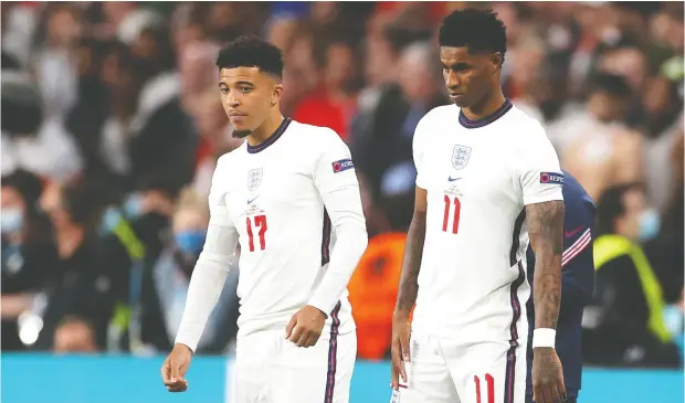  ?? CARL RECINE / POOL VIA REUTERS ?? England’s Marcus Rashford and Jadon Sancho were viciously targeted by angry fans after missing their penalty kicks in a tense 3-2 loss to Italy in
Sunday’s Euro 2020 final. A wave of online abuse included racist comments posted to their personal Instagram accounts.