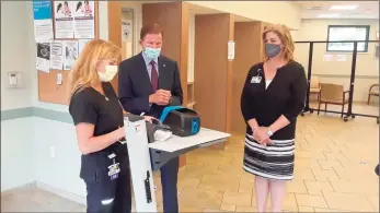  ?? Emily M. Olson / Hearst Connecticu­t Media / ?? Sen. Richard Blumenthal listens to head nurse Michelle Brady at Community Health & Wellness Center of Greater Torrington explain a new rapid testing machine for COVID-19, which provides results in 15 minutes instead of two or three days. Also pictured is Joanne Borduas, CHWC's CEO, right. Blumenthal visited the center Tuesday afternoon.