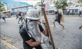  ?? Juan Barreto AFP/Getty Images ?? VENEZUELAN­S have held near-daily protests against the government of President Nicolas Maduro. His opponents say he wants to stay in power indefinite­ly.