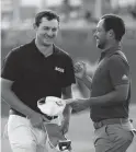  ?? GERALD HERBERT/AP ?? Patrick Cantlay greets teammate Xander Schauffele, right, on the 18th green after they completed the third round of the Zurich Classic on Saturday at TPC Louisiana in Avondale, La.