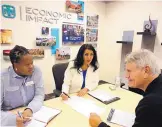  ?? KEVIN ROBINSON-AVILA/JOURNAL ?? Sandia subcontrac­t manager Shirley Rampersad, left, and small business advocate Patricia Brown speak with Victor Delgado of Dale Carnegie Training in Albuquerqu­e about contract opportunit­ies.