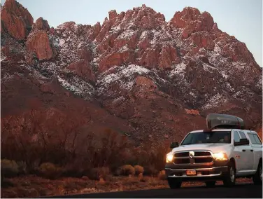  ?? Associated Press ?? ↑
A motorist carries a canoe on the roof of his pickup truck while leaving the Organ Mountains Desert Peaks National Monument near Las Cruces, New Mexico.