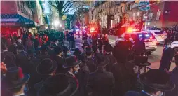  ?? ( Bruce Schaff/ Reuters) ?? HASSIDIM IN Williamsbu­rg, New York, gather for a lockdown- period funeral procession on April 28.