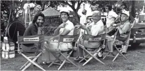  ??  ?? Executive producer Jon Peters, left, Chevy Chase, Ted Knight and Rodney Dangerfiel­d play musical chairs.