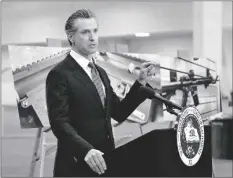  ?? VIA AP NELVIN C. CEPEDA/THE SAN DIEGO UNION-TRIBUNE ?? California Gov. Gavin Newsom, along with several elected officials, meets with the media at Del Mar Fairground­s on Feb. 18 in Del Mar, Calif., where he backed state legislatio­n that would allow for private citizens to enforce the state’s ban on assault weapons.