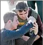  ?? AP/WILFREDO LEE ?? A student shows a law enforcemen­t officer an image from his phone Wednesday after the shooting.