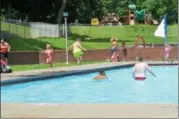  ?? NICHOLAS BUONANNO-NBUONANNO@TROYRECORD.COM ?? Seven-year-old Cohoes resident James Bishop, in the green shorts, dives into Lansing Pool Monday afternoon.