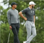  ?? — AFP ?? Tiger Woods and Dustin Johnson in the US Open second round at the Shinnecock Hills Golf Club in Southampto­n, New York, on Thursday.