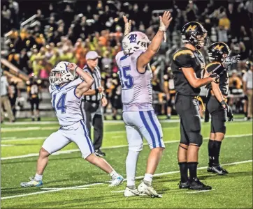  ?? Courtney Couey, Ringgold Tigers Shots ?? Ringgold kicker Landon Eaker (14) and holder Cole Carlock (35) celebrate Eaker’s last-second 43-yard field goal that completed the Tigers’ 31-28 comeback victory at North Murray. It was the Region 6-AAA opener for both teams.