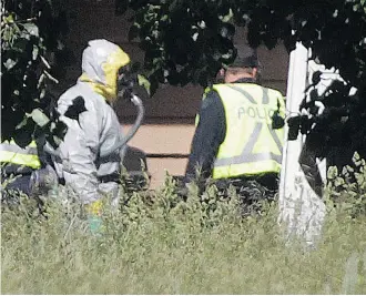  ?? Ted Rhodes/Calgary Herald ?? Police in Hazmat suits Wednesday investigat­e the farm of the family of Douglas Garland, the person of interest in the disappeara­nce of Nathan O’Brien and his grandparen­ts Alvin and Kathryn Liknes.