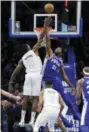  ?? MICHAEL PEREZ — THE ASSOCIATED PRESS ?? The Philadelph­ia 76ers’ Joel Embiid (21) blocks a shot from the Wizards’ Ian Mahinmi (28) in the second half of an NBA game, Tuesday in Philadelph­ia. The 76ers won 115-102.