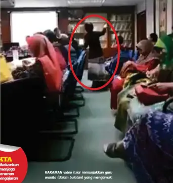  ??  ?? RAKAMAN video tular menunjukka­n guru wanita (dalam bulatan) yang mengamuk.