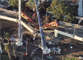  ?? Fernando Llano / Associated Press ?? An aerial view of subway cars dangling at an angle from a collapsed elevated section of the metro, in Mexico City on Tuesday.