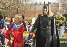  ??  ?? Superheroe­s Gretta Freeman (left) and Jaqui Blackburn wave to the crowd.