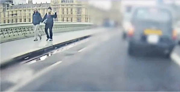  ??  ?? Kurt Cochran, one of the victims, walking across the bridge with his wife Melissa