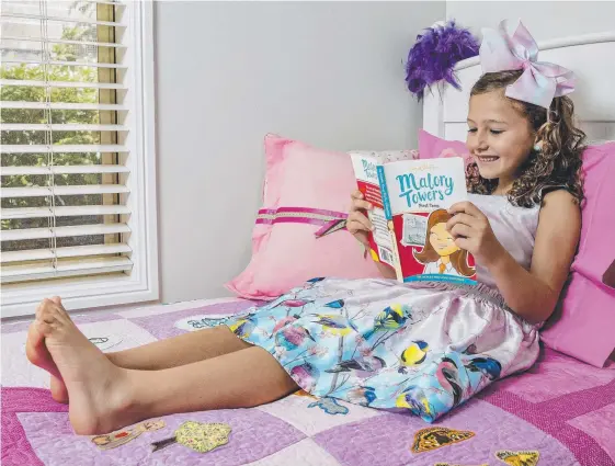  ?? Picture: JERAD WILLIAMS ?? Nicole Moss, 7, reading Enid Blyton's Malory Towers First Term, which is available with the Gold Coast Bulletin tomorrow.