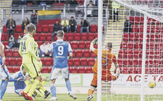  ??  ?? Joe Shaughness­y, grounded, scores the equaliser for St Johnstone but the evening ended in disappoint­ment for the Perth club as they went down to Lithuanian side FK Trakai.