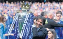  ??  ?? Chelsea manager Antonio Conte lifts the Premier League trophy last year.