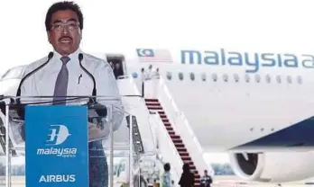  ?? PIC BY ROSELA ISMAIL ?? Second Finance Minister Datuk Seri Johari Abdul Ghani speaking after witnessing the arrival of MAS’ newest airplane, the Airbus A350-900, in Sepang yesterday.