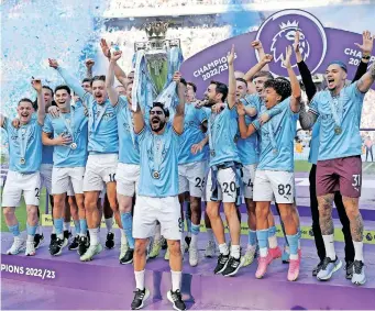  ?? | Reuters ?? MANCHESTER City’s Ilkay Gundogan lifts the trophy as he celebrates with teammates after winning the Premier League.