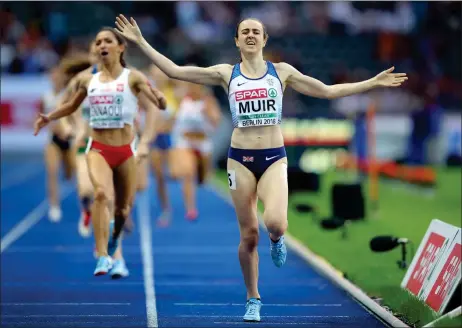  ??  ?? „ Scotland’s Laura Muir celebrates as she crosses the line to win the gold medal in the women’s 1,500m final at the European Athletics Championsh­ips in Berlin last night. Fellow Scot Eilish Mccolgan won silver in the women’s 5,000m.
