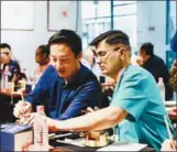  ?? ?? From left: Professor Liu Hongli teaches internatio­nal students to write calligraph­y at Beijing University of Technology in October 2019. Vietnamese PhD student Le Duc An attends a cultural event to make seals at the Beijing Ceramic Museum on May 5, 2023. Korean student Kim Joon-yeop practises calligraph­y during a class on Sept 13, 2023.