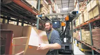  ?? Anne Cusack Los Angeles Times ?? DANIEL STEELE loads merchandis­e at a Target center in Ontario, Calif. Employment at warehouses has doubled since 2000, yet annual wages for most workers haven’t grown at the same rate.