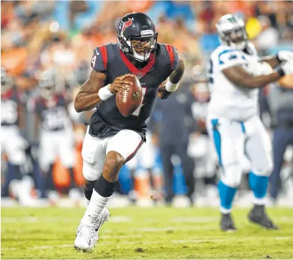  ?? Brett Coomer / Houston Chronicle ?? Texans quarterbac­k Deshaun Watson breaks out of the pocket on his way to a 15-yard touchdown run against the Panthers during the third quarter of Wednesday’s preseason opener. He passed for 179 yards and ran for 24 more in his NFL debut.