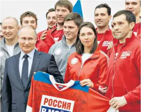  ??  ?? Neutral team: Vladimir Putin with athletes who competed at the Winter Olympics
