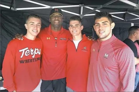  ?? Courtesy of Hunter Baxter ?? Maryland wrestling coach Kerry McCoy, center left, and Pine-Richland grad Brendan Burnham, right, will welcome two more Rams to the roster next season: Hunter Baxter, left, and Garret Burnham.