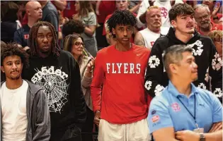  ?? DAVID JABLONSKI/STAFF ?? Dayton players watch the Red Scare play DaGuys STL in the first round of The Basketball Tournament on Saturday at UD Arena. Pictured (from left) are Javon Bennett, Jaiun Simon, Hamad Mousa and Isaac Jack.