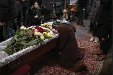  ?? (AP/Andrew Kravchenko) ?? Relatives, friends and comrades mourn Wednesday during the funeral for Ukrainian serviceman Sergii Myronovat at St. Michael’s Golden-Domed Monastery in Kyiv, Ukraine. Myronovat was killed fighting Russian troops in Donetsk region of eastern Ukraine.