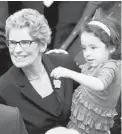  ?? FRANK GUNN/THE CANADIAN PRESS ?? Wynne with granddaugh­ter Olivia after her swearing-in as premier in February.