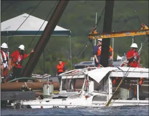  ?? The Associated Press ?? RECOVERED: The duck boat that sank in Table Rock Lake in Branson, Mo., is raised Monday. The boat went down Thursday evening after a thundersto­rm generated near-hurricane strength winds.