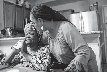  ?? Jon Shapley / Staff photograph­er ?? Kadiatu Lamin is comforted by her sister, Sarah Kamara. Lamin, a Houston nurse, is filled with anxiety at the thought of her son, Mohamed Gordon, returning partially blind to Sierra Leone, where he has no family.