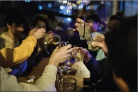  ?? (AP/Lewis Joly) ?? People share a toast Thursday on their last gathering for now on a bar terrace in Paris as France prepared for a new monthlong lockdown, and other European countries considered new measures as coronaviru­s cases soar.