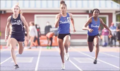  ?? H John Voorhees III / Hearst Connecticu­t Media ?? Danbury’s Alanna Smith, center, finished first in the 100-meter dash at the FCIAC championsh­ip in May.