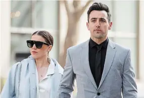  ?? COLE BURSTON THE CANADIAN PRESS ?? Canadian musician Jacob Hoggard arrives alongside his wife, Rebekah Asselstine, for his sex assault trial at a Toronto courthouse on Tuesday.