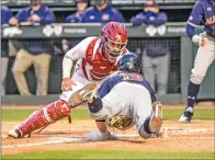  ?? CRAVEN WHITLOW/NATE Allen Sports Service ?? Razorback catcher Casey Optiz, 12, tags out an Auburn runner Thursday night at Baum-walker Stadium in Fayettevil­le. Auburn edged the Hogs 2-1.