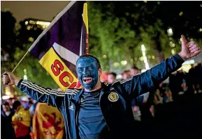  ?? GETTY IMAGES ?? Scotland fans celebrate the 0-0 draw in Leicester Square while England captain Harry Kane, right, is taken off at Wembley by coach Gareth Southgate.