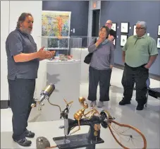  ??  ?? Art Gallery of Swift Current Director and Curator Kim Houghtalin­g speaks during the public reception for the Summer Salon, July 27.